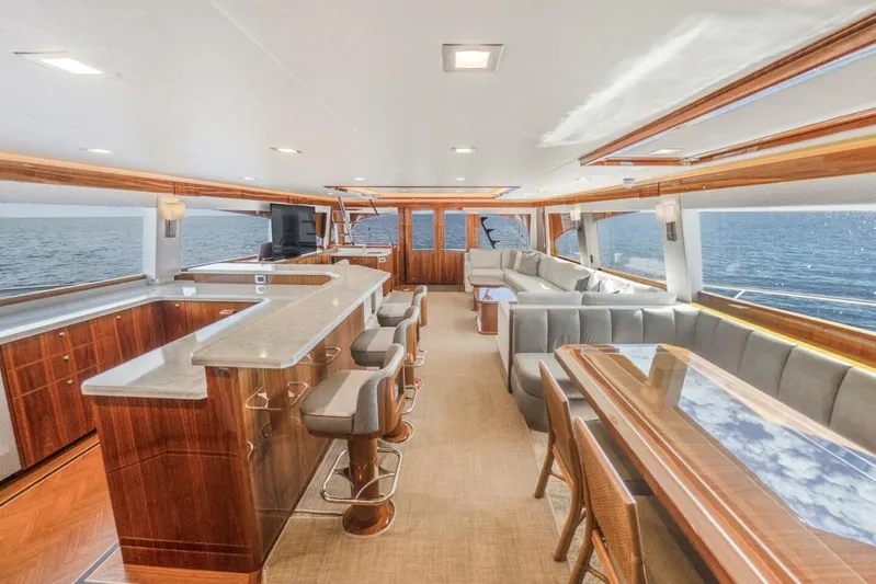 Marlin Magic Yacht Photos Pics Luxurious interior of 2021 Viking 92 Skybridge yacht with elegant seating and ocean view.