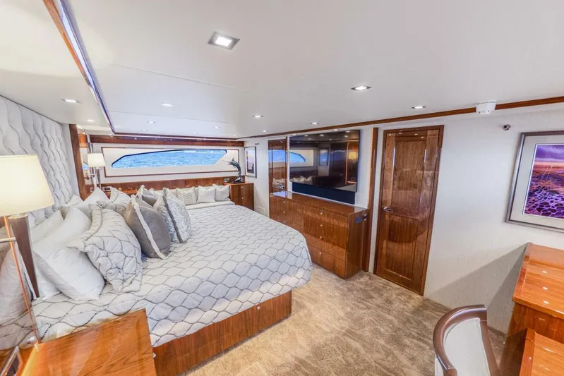 Marlin Magic Yacht Photos Pics Luxurious bedroom interior of 2021 Viking 92 Skybridge yacht with elegant decor and ocean view.