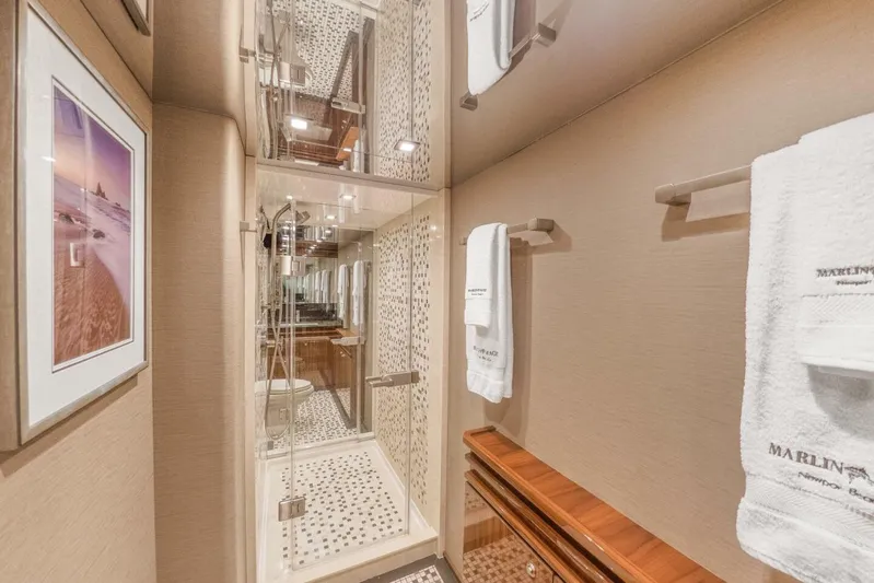 Marlin Magic Yacht Photos Pics Luxurious bathroom on 2021 Viking 92 Skybridge yacht with elegant shower and plush towels.