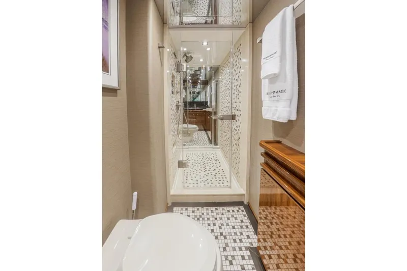 Marlin Magic Yacht Photos Pics Luxurious bathroom in 2021 Viking 92 Skybridge yacht with elegant shower and modern fixtures.