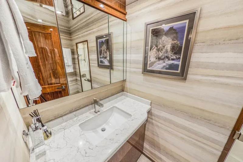Marlin Magic Yacht Photos Pics Luxurious bathroom in 2021 Viking 92 Skybridge yacht with marble countertop and elegant decor.
