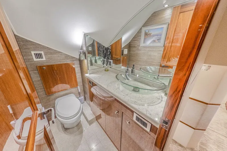 Marlin Magic Yacht Photos Pics Luxurious bathroom in 2021 Viking 92 Skybridge yacht with glass sinks and marble countertop.