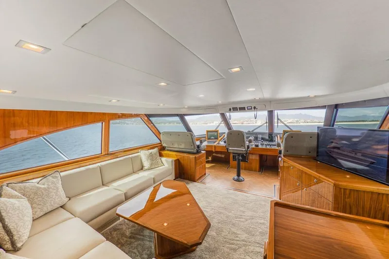 Marlin Magic Yacht Photos Pics Luxurious interior of 2021 Viking 92 Skybridge yacht with elegant seating and panoramic views.