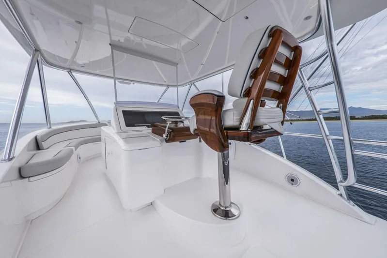 Marlin Magic Yacht Photos Pics Luxurious 2021 Viking 92 Skybridge yacht interior with sleek helm and seating.