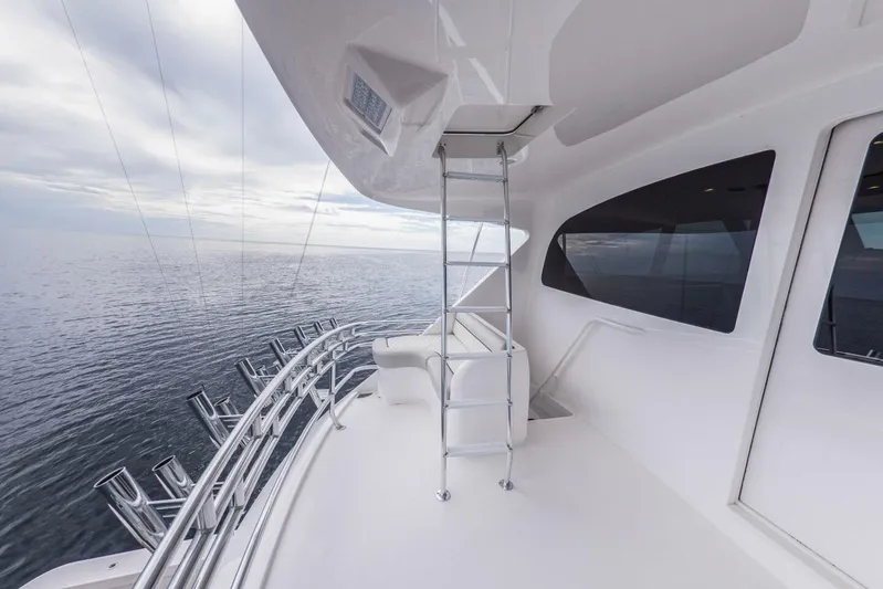 Marlin Magic Yacht Photos Pics 2021 Viking 92 Skybridge yacht deck with ocean view and sleek design.