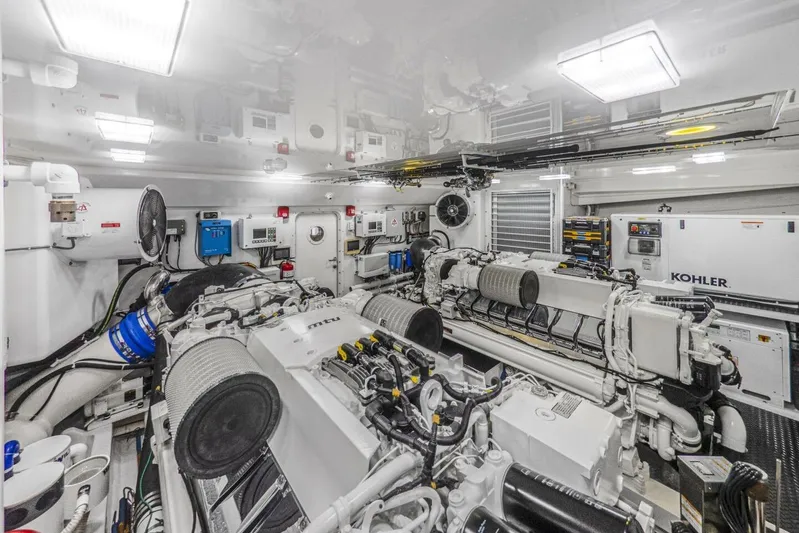 Marlin Magic Yacht Photos Pics Engine room of 2021 Viking 92 Skybridge yacht with MTU engines and Kohler generator.