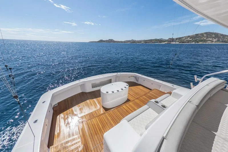 Marlin Magic Yacht Photos Pics Luxurious 2021 Viking 92 Skybridge yacht with spacious deck overlooking serene ocean waters.