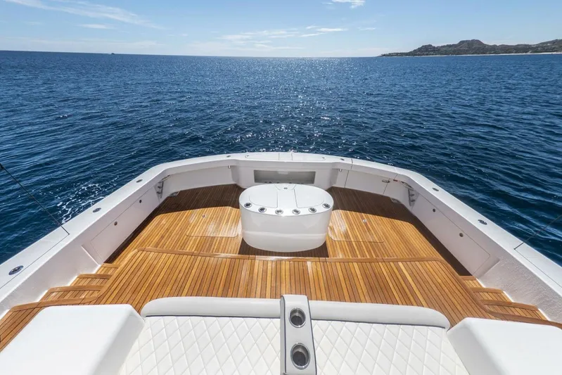 Marlin Magic Yacht Photos Pics Luxurious 2021 Viking 92 Skybridge yacht deck with ocean view and elegant wood finish.