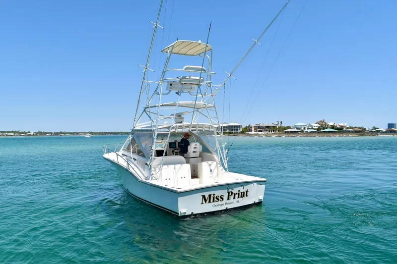 Miss Print Yacht Photos Pics 2006 Carolina Classic 32 boat on clear blue water, sunny day, distant shoreline.