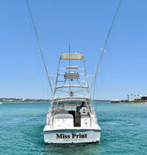 Miss Print Yacht Photos Pics 2006 Carolina Classic 32 boat on clear blue water, rear view.