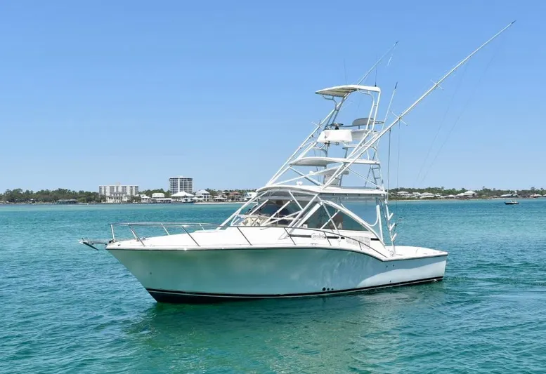 Miss Print Yacht Photos Pics 2006 Carolina Classic 32 boat on clear blue water, sunny day, distant shoreline.