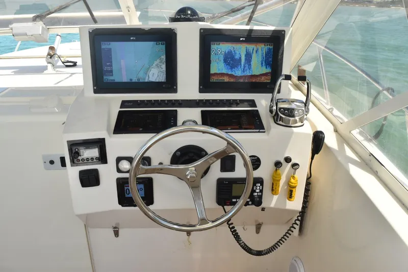 Miss Print Yacht Photos Pics Helm of 2006 Carolina Classic 32 with dual navigation screens and steering wheel.