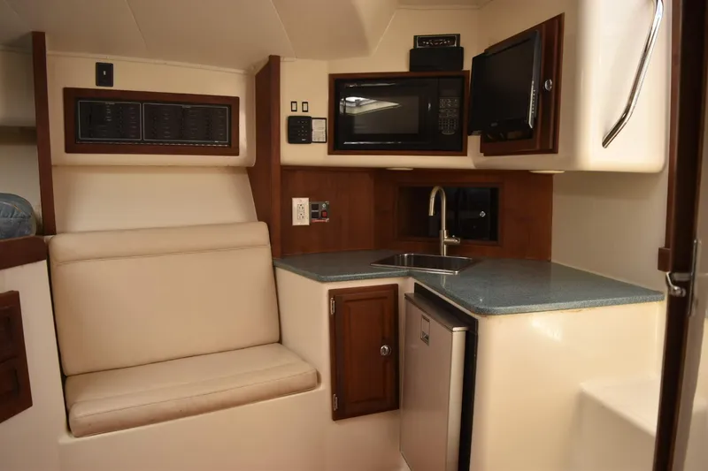 Miss Print Yacht Photos Pics Interior of 2006 Carolina Classic 32 boat with kitchenette and seating area.