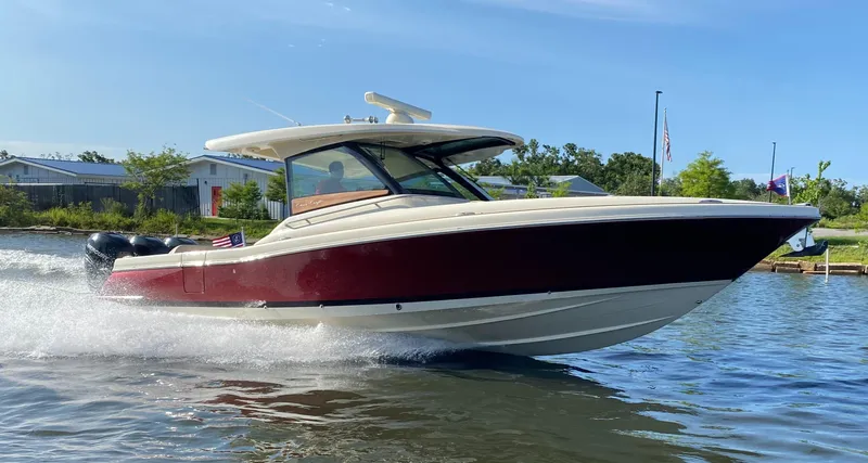  Yacht Photos Pics 2023 Chris-Craft Calypso 35 cruising on a sunny day, showcasing sleek design and performance.