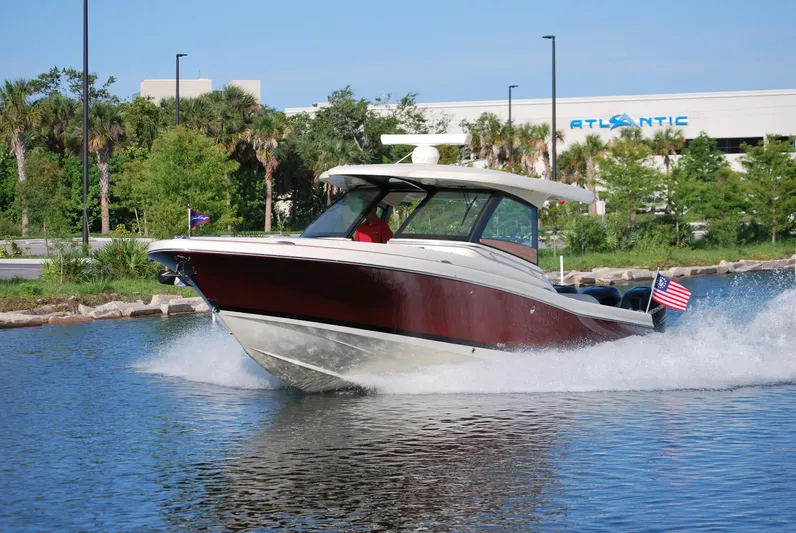  Yacht Photos Pics 2023 Chris-Craft Calypso 35 cruising on water, American flag displayed.
