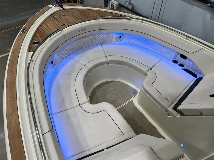  Yacht Photos Pics 2023 Chris-Craft Calypso 35 boat interior with elegant seating and ambient blue lighting.