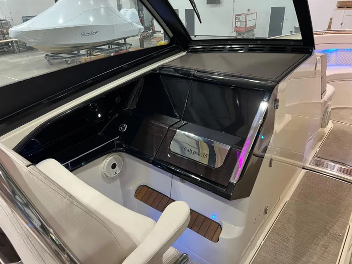  Yacht Photos Pics 2023 Chris-Craft Calypso 35 boat interior with sleek dashboard and seating.
