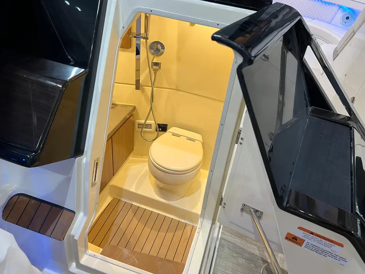 Yacht Photos Pics Luxurious bathroom on 2023 Chris-Craft Calypso 35 boat, featuring modern fixtures and wood accents.