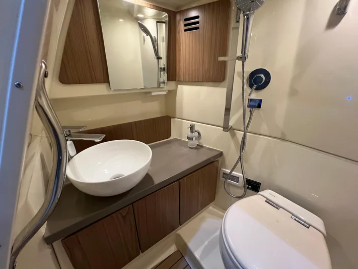  Yacht Photos Pics Luxurious bathroom in 2023 Chris-Craft Calypso 35 boat with modern fixtures and elegant design.