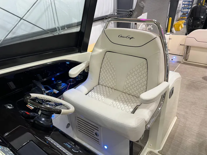  Yacht Photos Pics Captain's seat of 2023 Chris-Craft Calypso 35, featuring luxurious white upholstery and steering wheel.