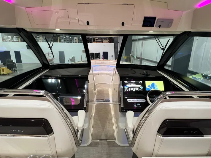  Yacht Photos Pics 2023 Chris-Craft Calypso 35 helm with modern navigation displays and luxurious seating.