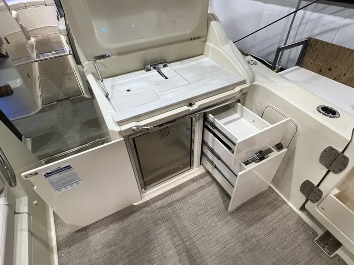  Yacht Photos Pics 2023 Chris-Craft Calypso 35 boat interior with kitchenette and storage drawers.