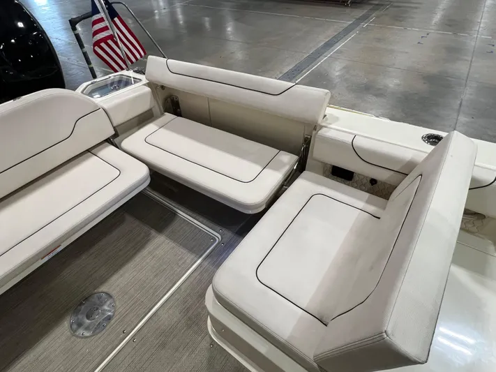  Yacht Photos Pics 2023 Chris-Craft Calypso 35 boat interior with white seating and American flag.
