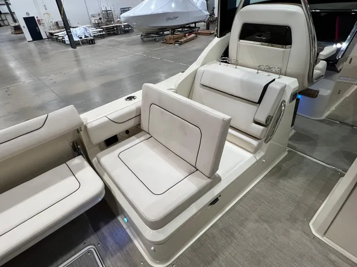  Yacht Photos Pics 2023 Chris-Craft Calypso 35 interior seating in a spacious showroom.