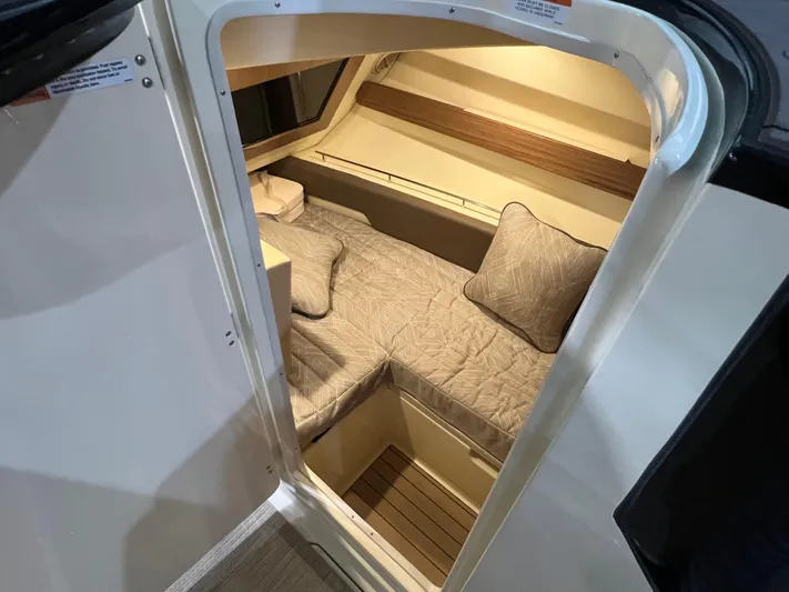  Yacht Photos Pics 2023 Chris-Craft Calypso 35 cabin interior with cozy bedding and cushions.