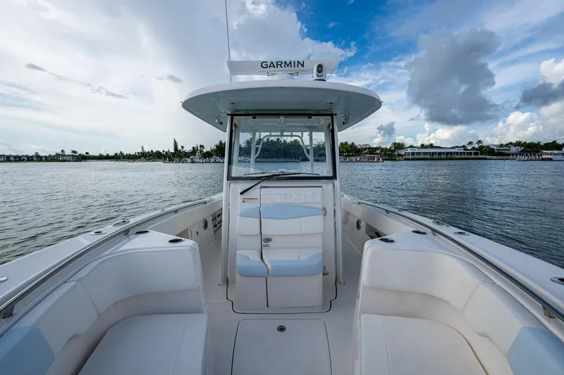 Mimi Too Yacht Photos Pics 2023 Robalo R302 Center Console boat on calm water under a partly cloudy sky.