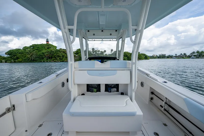 Mimi Too Yacht Photos Pics 2023 Robalo R302 Center Console boat on water, featuring spacious seating and scenic backdrop.