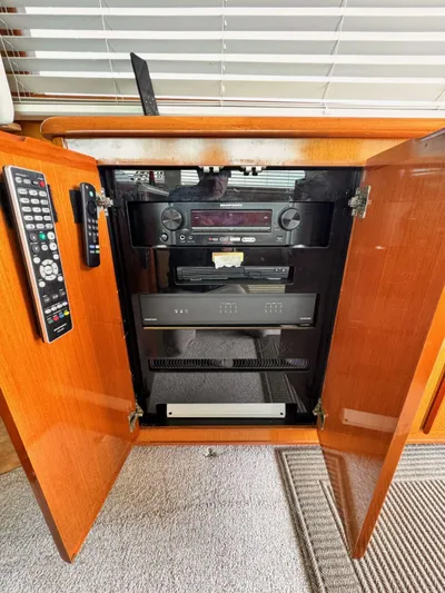 My Way Yacht Photos Pics 1999 Viking SF 50 HT yacht entertainment system with wooden cabinet and remote control.