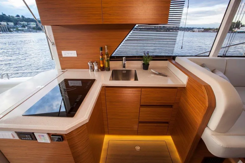 Pastiche Yacht Photos Pics Modern kitchen interior on 2019 Greenline Hybrid yacht with sleek wood finish and waterfront view.