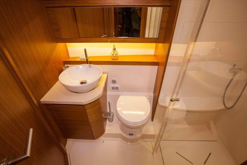 Pastiche Yacht Photos Pics Luxurious bathroom in 2019 Greenline Hybrid yacht with modern fixtures and elegant wood accents.