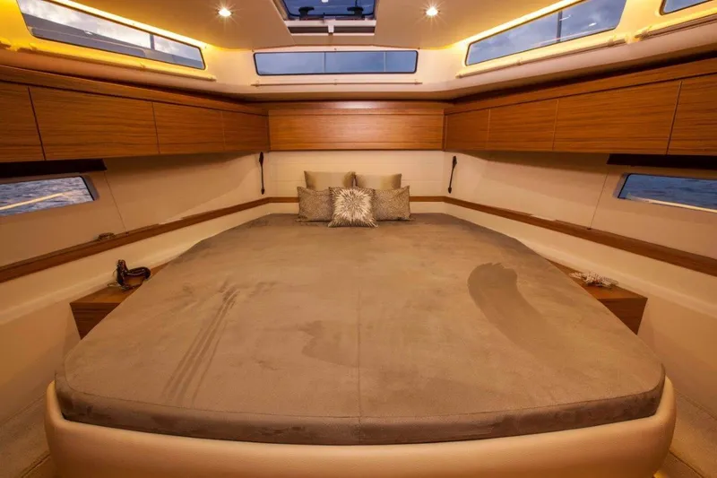 Pastiche Yacht Photos Pics Luxurious interior of 2019 Greenline Hybrid yacht with spacious bed and elegant wood finish.
