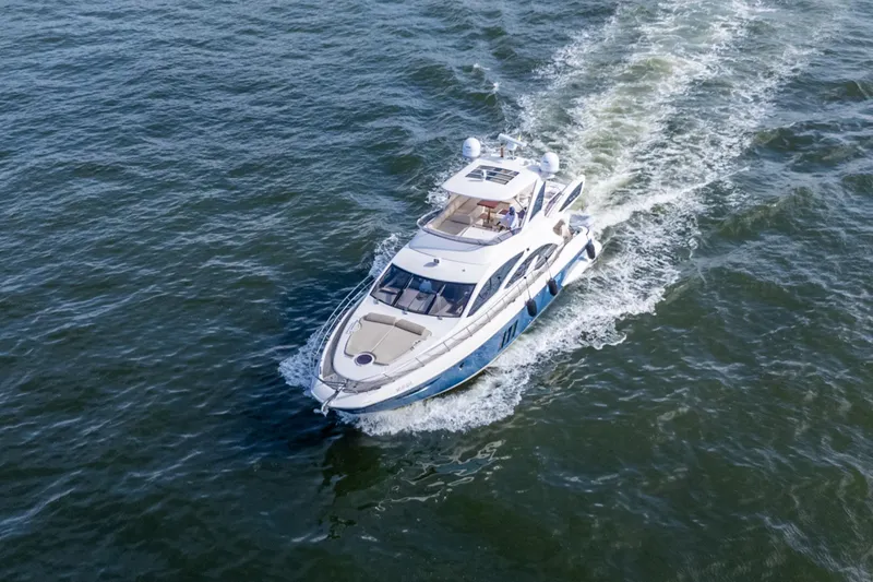 The Real D Yacht Photos Pics Azimut 60 Flybridge 2013 yacht cruising on open water, aerial view.