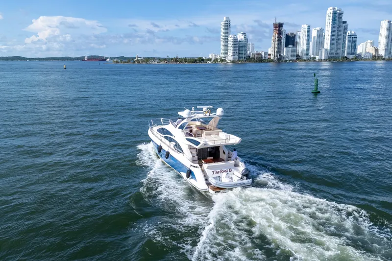 The Real D Yacht Photos Pics Azimut 60 Flybridge yacht cruising near city skyline, 2013 model.