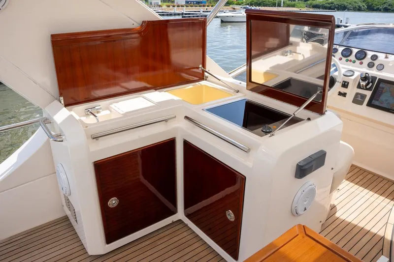 The Real D Yacht Photos Pics Azimut 60 Flybridge 2013 yacht interior with open storage compartments and control panel.