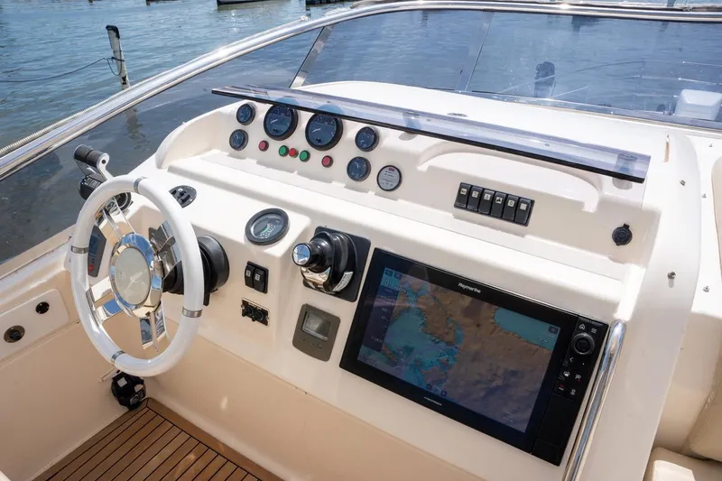 The Real D Yacht Photos Pics Helm of 2013 Azimut 60 Flybridge yacht with navigation controls and display.
