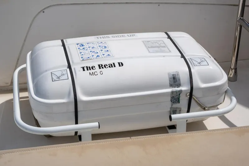 The Real D Yacht Photos Pics Life raft on 2013 Azimut 60 Flybridge yacht deck, labeled "The Real D."