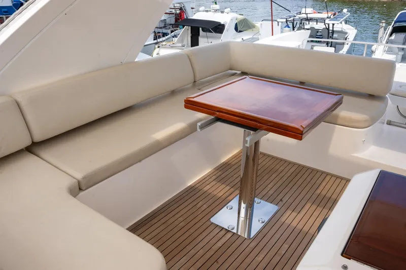 The Real D Yacht Photos Pics Azimut 60 Flybridge 2013 yacht with elegant seating and wooden table on deck.