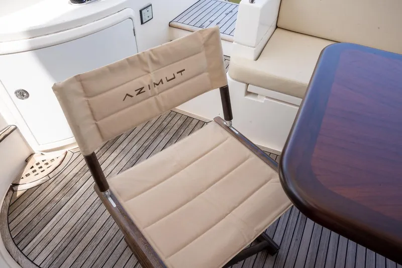 The Real D Yacht Photos Pics Azimut 60 Flybridge 2013 yacht interior with branded chair and wooden table.