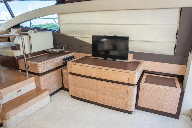 The Real D Yacht Photos Pics Luxurious interior of 2013 Azimut 60 Flybridge yacht with modern TV and elegant wood cabinetry.