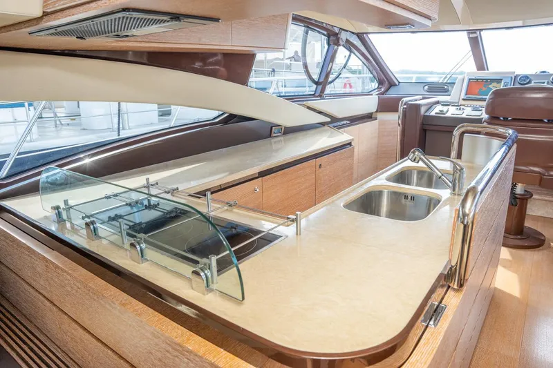 The Real D Yacht Photos Pics Luxurious interior of 2013 Azimut 60 Flybridge yacht with modern kitchen amenities.
