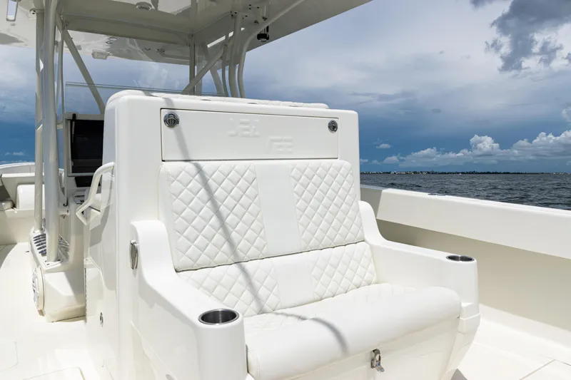  Yacht Photos Pics 2017 SeaVee 370z boat with white quilted seating, ocean view, and cloudy sky.