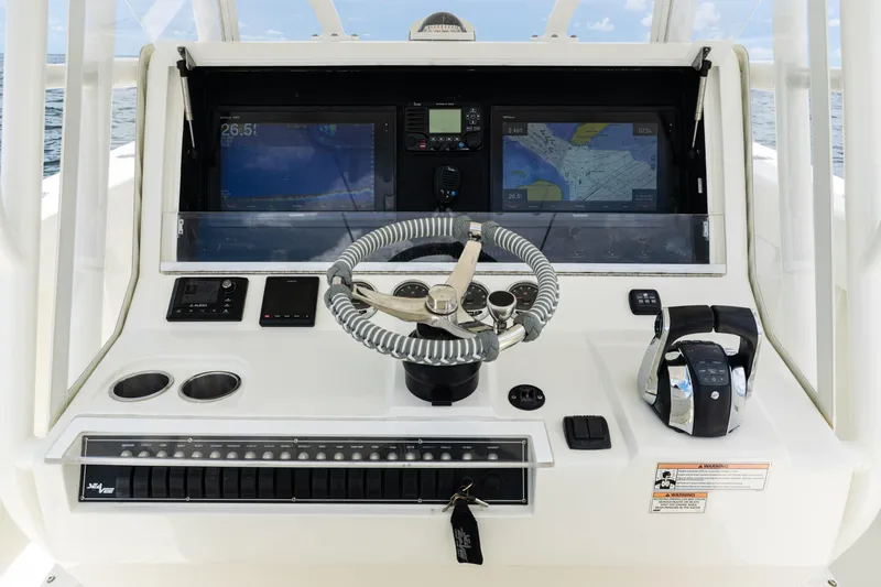  Yacht Photos Pics 2017 SeaVee 370z boat dashboard with steering wheel, navigation screens, and controls.
