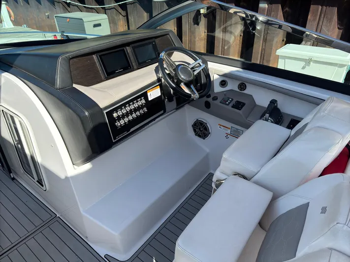 The Good Life Yacht Photos Pics 2019 Four Winns H350 boat cockpit with steering wheel and control panel.