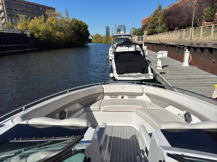 The Good Life Yacht Photos Pics 2019 Four Winns H350 boat docked on a scenic river with urban backdrop.