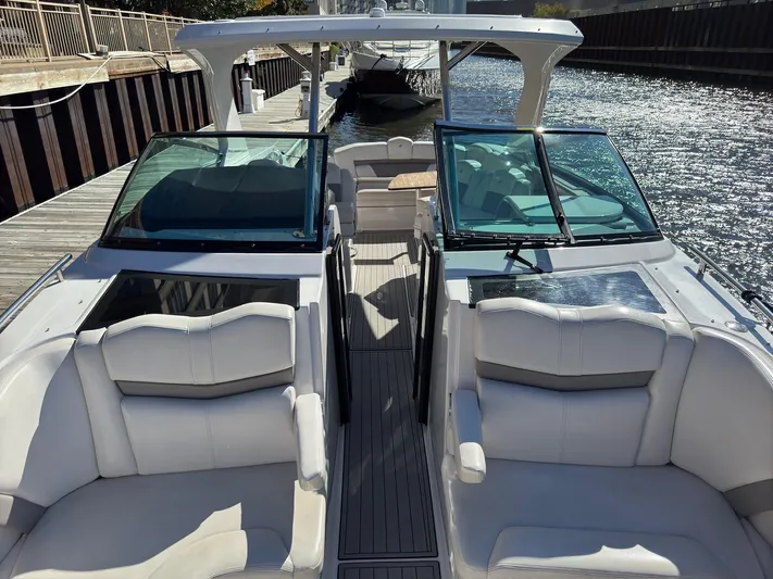 The Good Life Yacht Photos Pics 2019 Four Winns H350 boat with spacious seating and sleek design docked by the water.