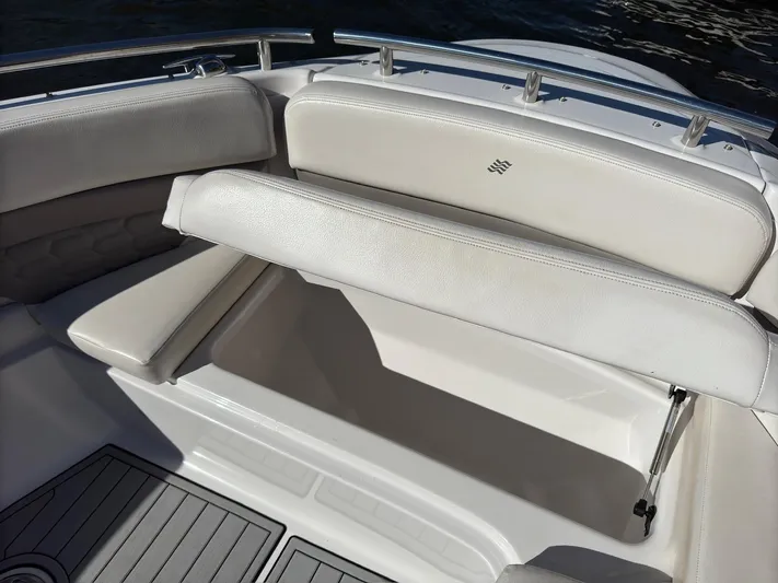 The Good Life Yacht Photos Pics 2019 Four Winns H350 boat with open storage compartment and cushioned seating.